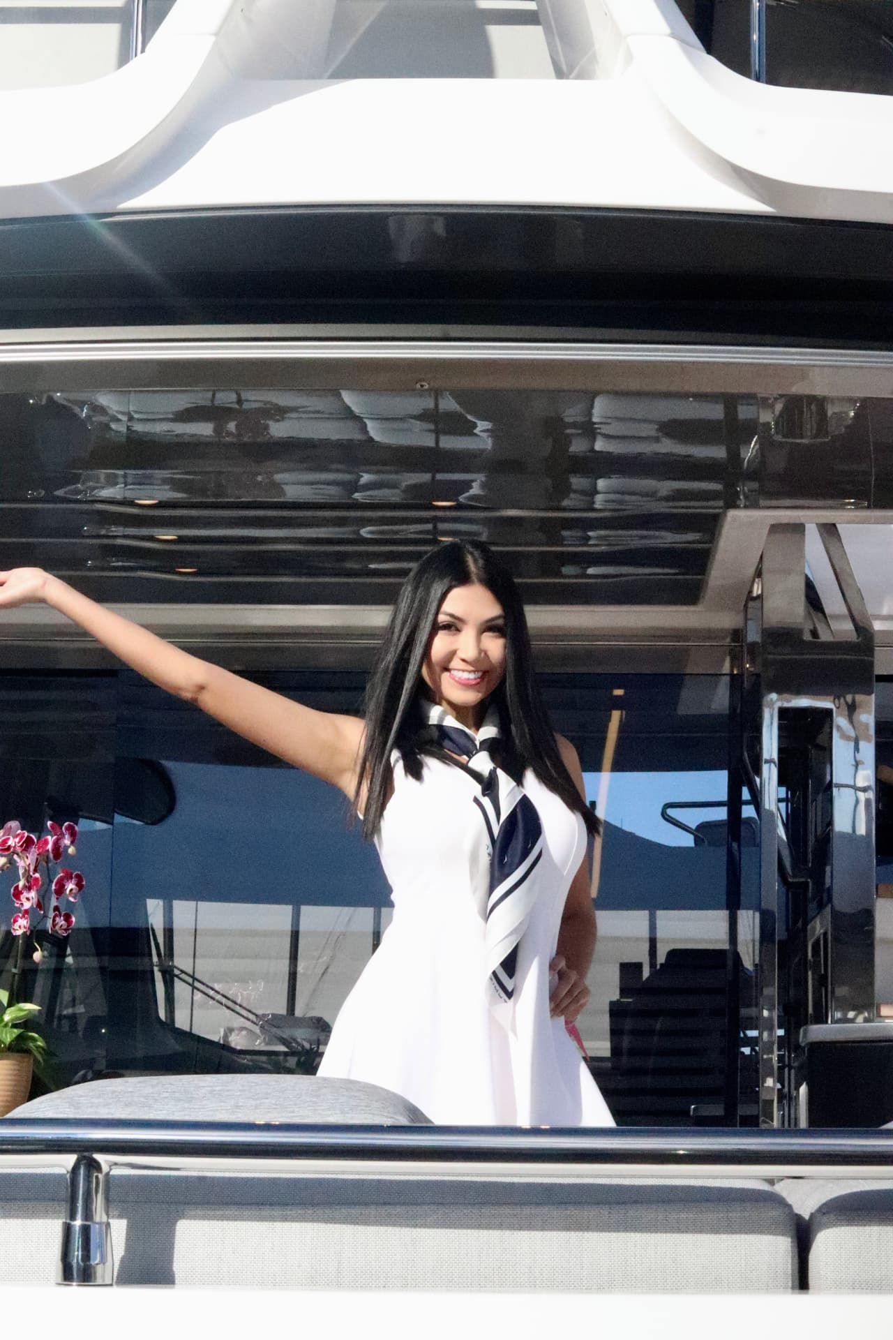 Yacht stewardess welcoming guests aboard